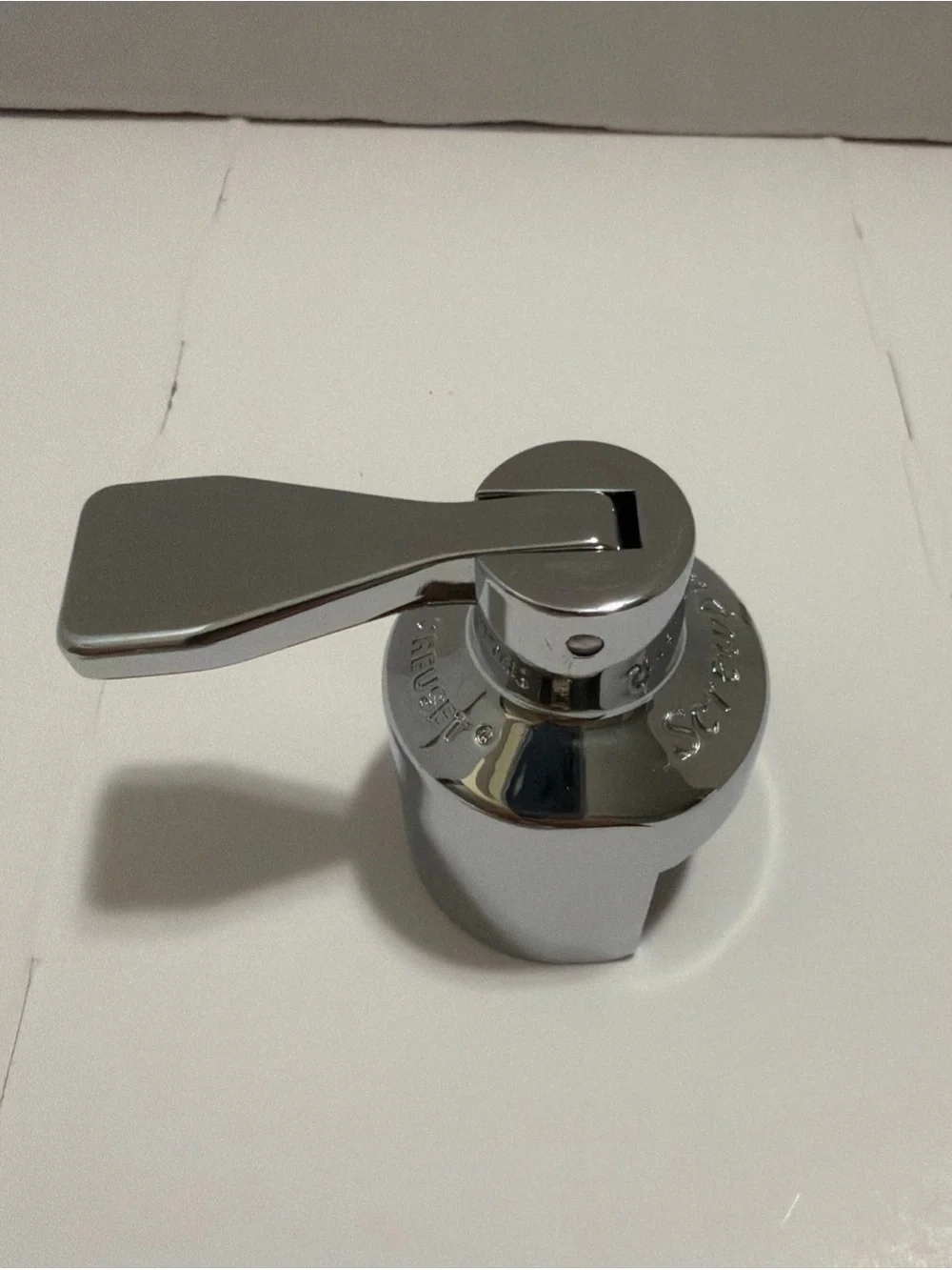 Le Creuset Champagne Crown Sealer, specifically a satin chrome.